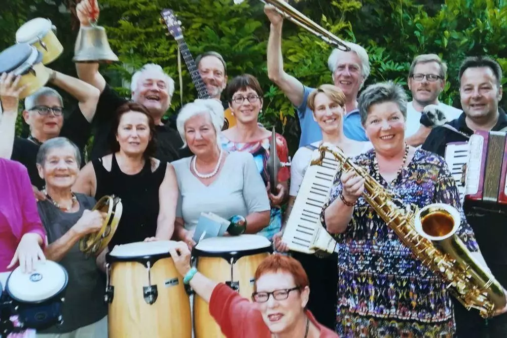 Gruppenfoto von Menschen mit Instrumenten.