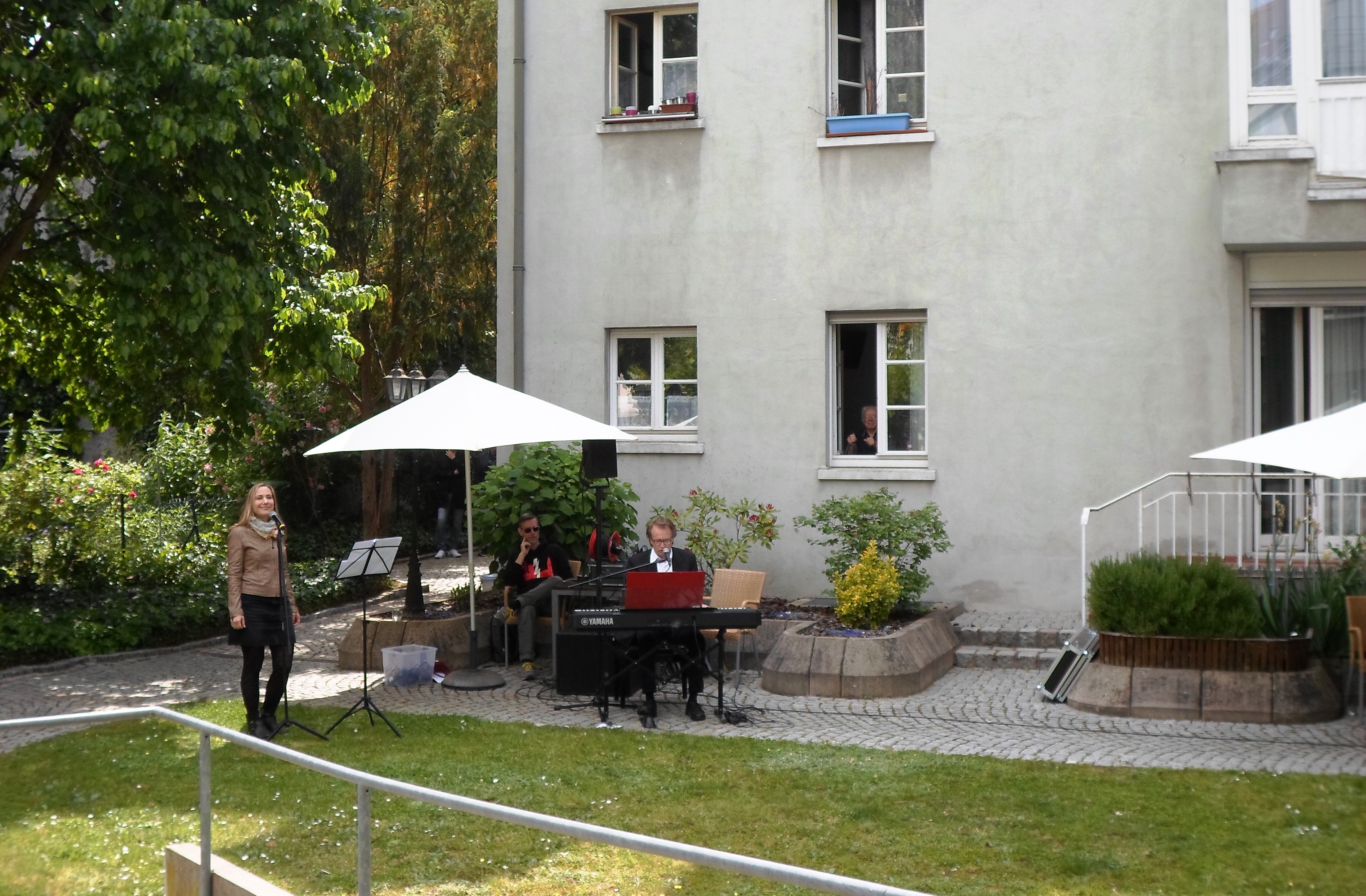 Zwei Menschen sind im Garten und machen Musik.